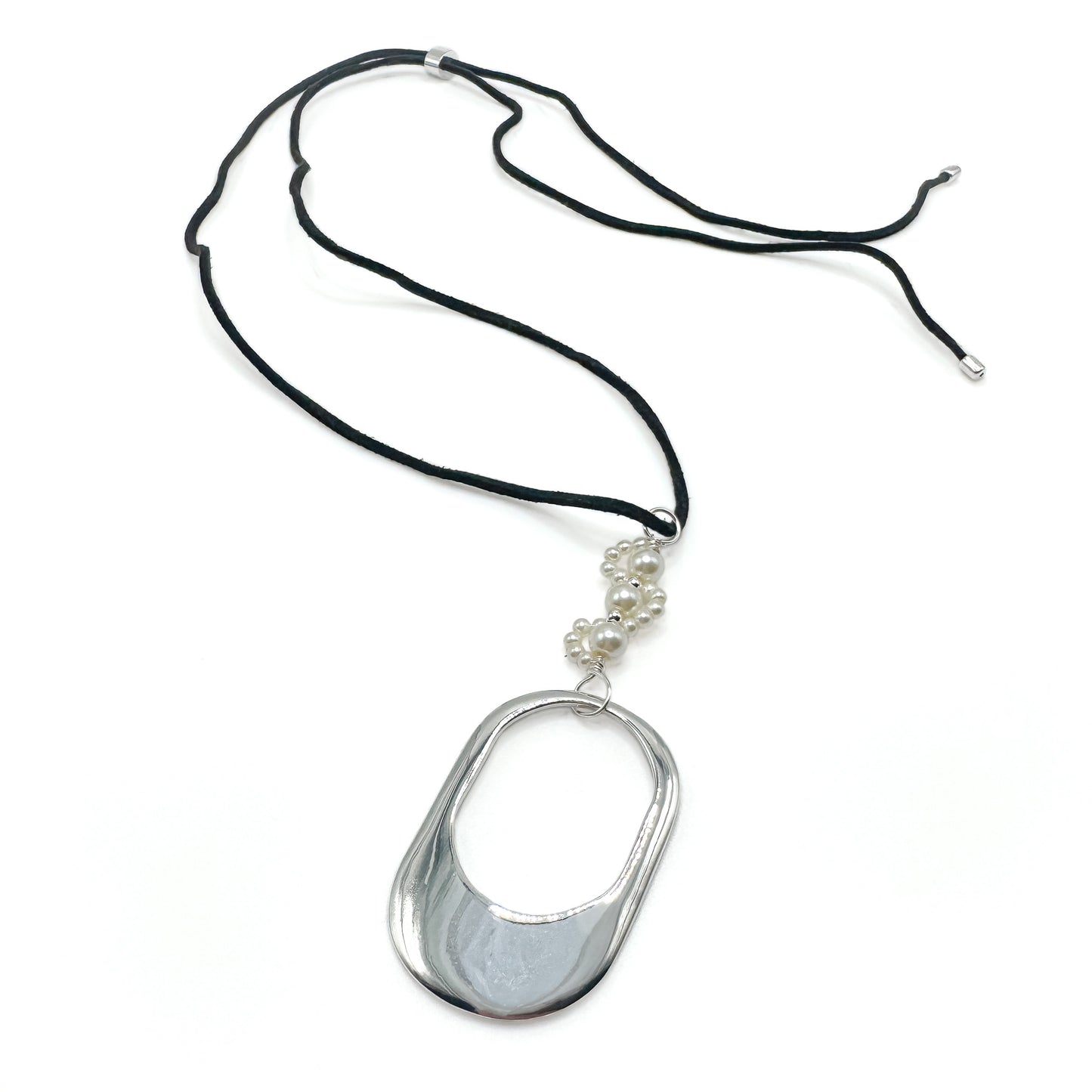 Necklace with a large silver pendant and smaller beads on a black cord against a white background