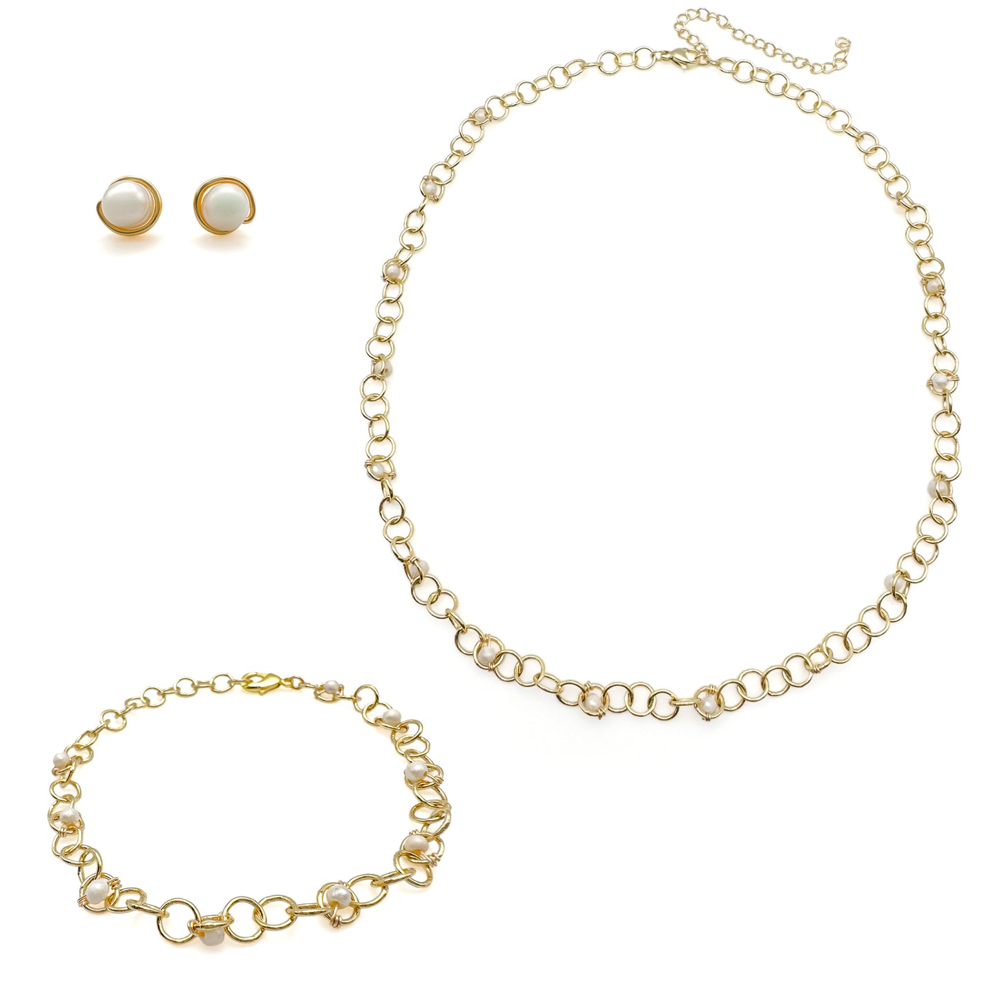 Gold necklace, bracelet, and earrings set on a white background