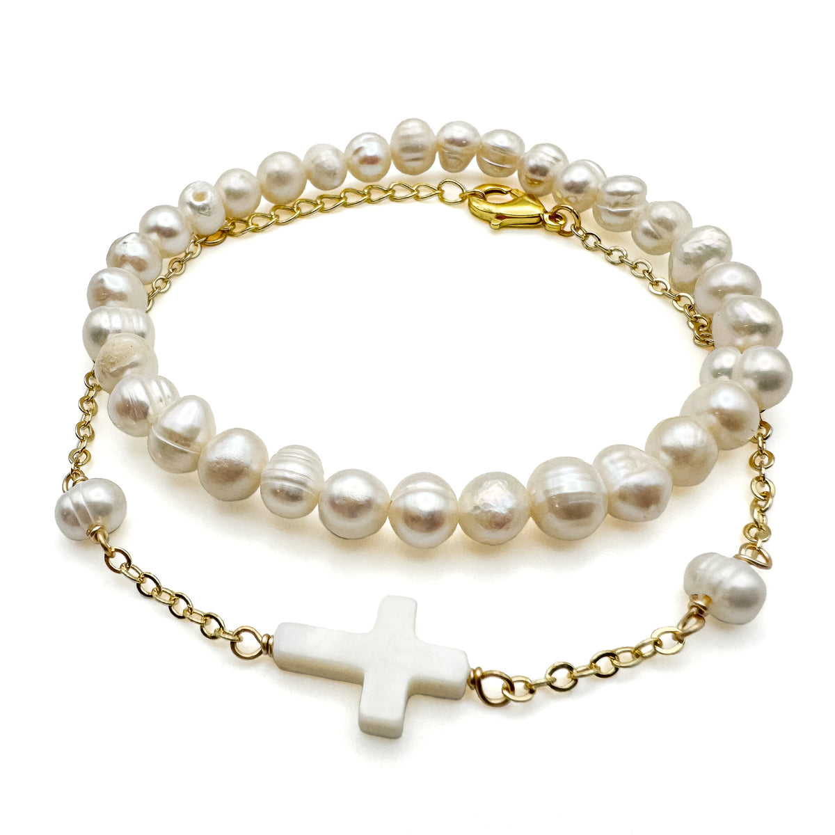 Two piece gold bracelet set with pearl beaded stretch bracelet and gold chain bracelet with mother of pearl cross charm
