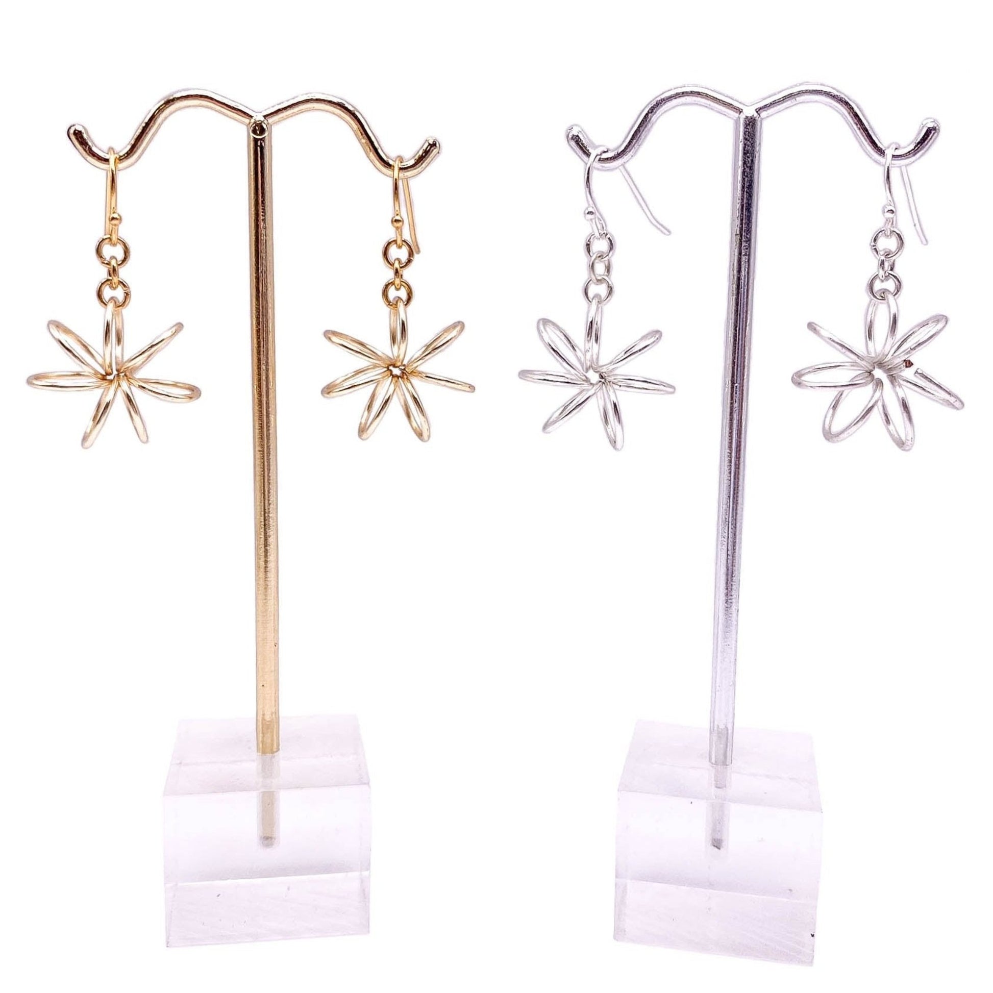 Gold silver flower earrings displayed