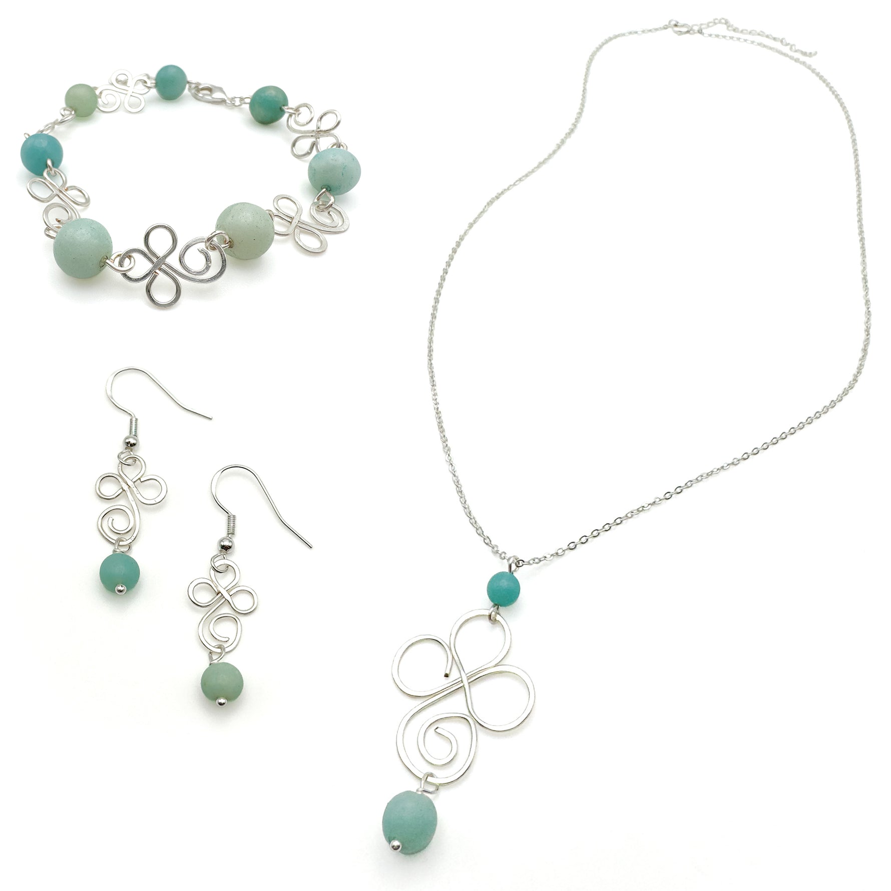 Jewelry set with necklace, bracelet, and earrings featuring turquoise beads on a white background