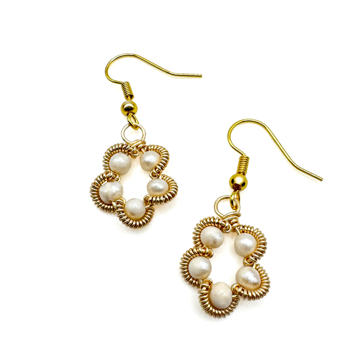 Gold dangle earrings with pearl and wire-wrapped flowers