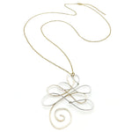 Gold necklace with a decorative pendant on a white background