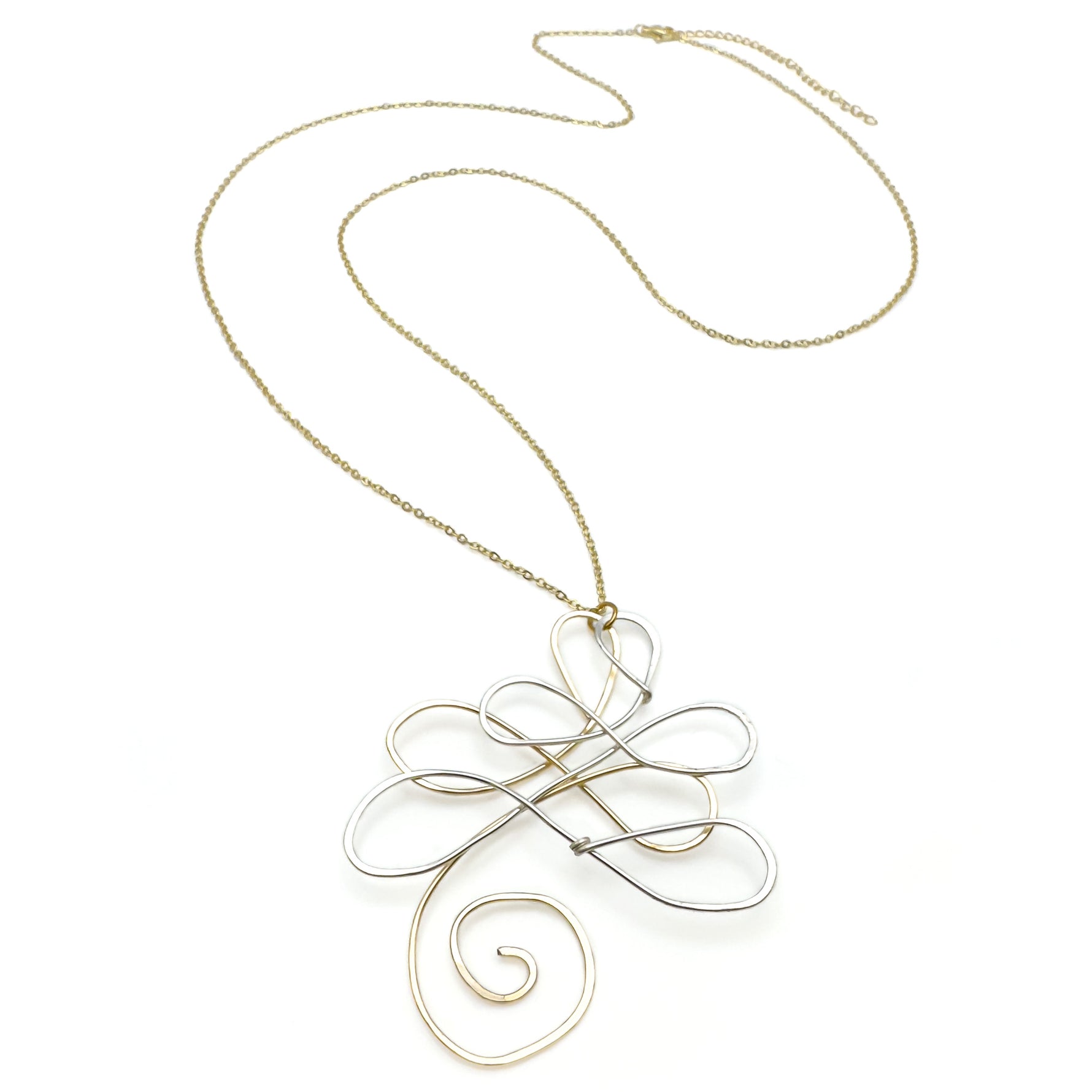 Gold necklace with a decorative pendant on a white background