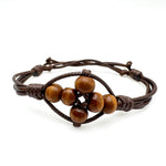 Brown adjustable cord bracelet with woven wooden bead cross