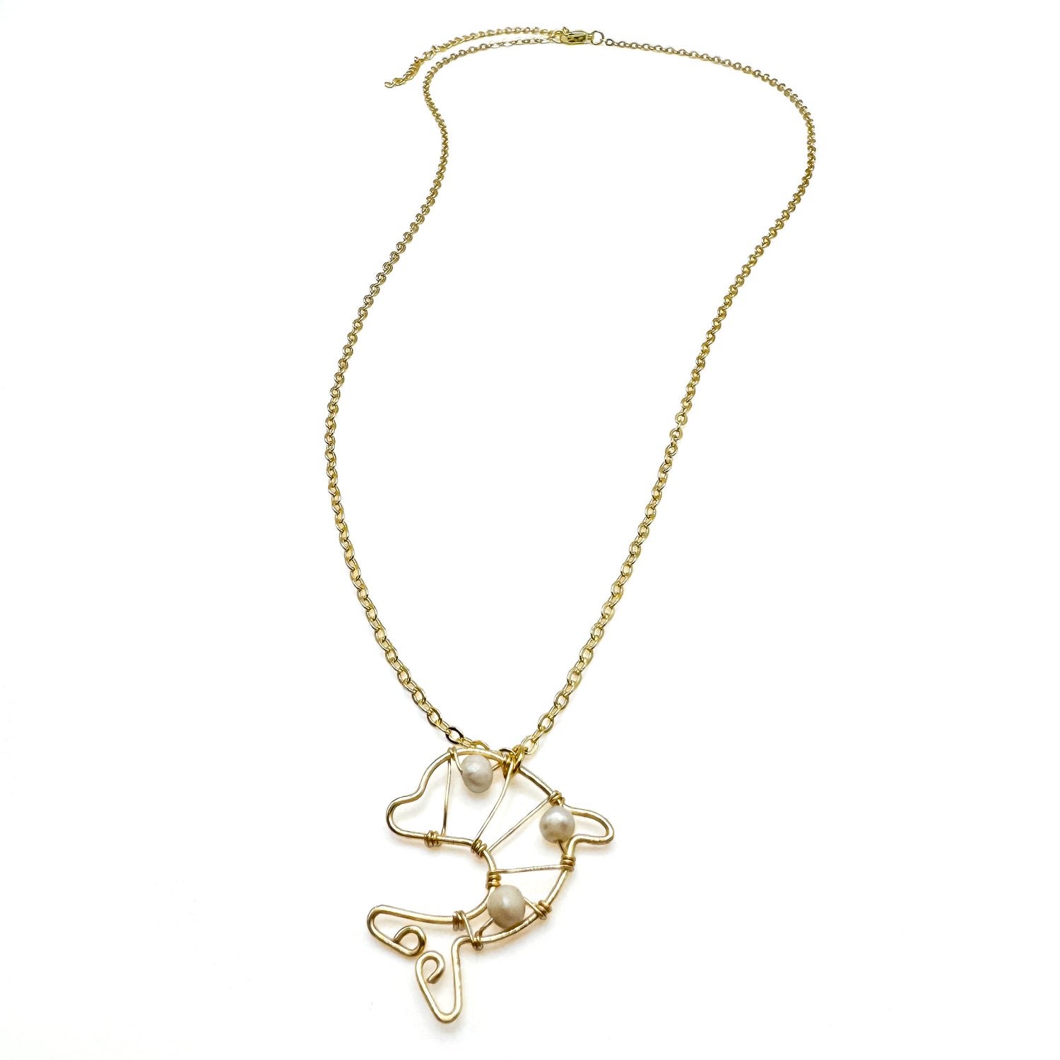 Long gold necklace with wire-wrapped gold and pearl dolphin pendant