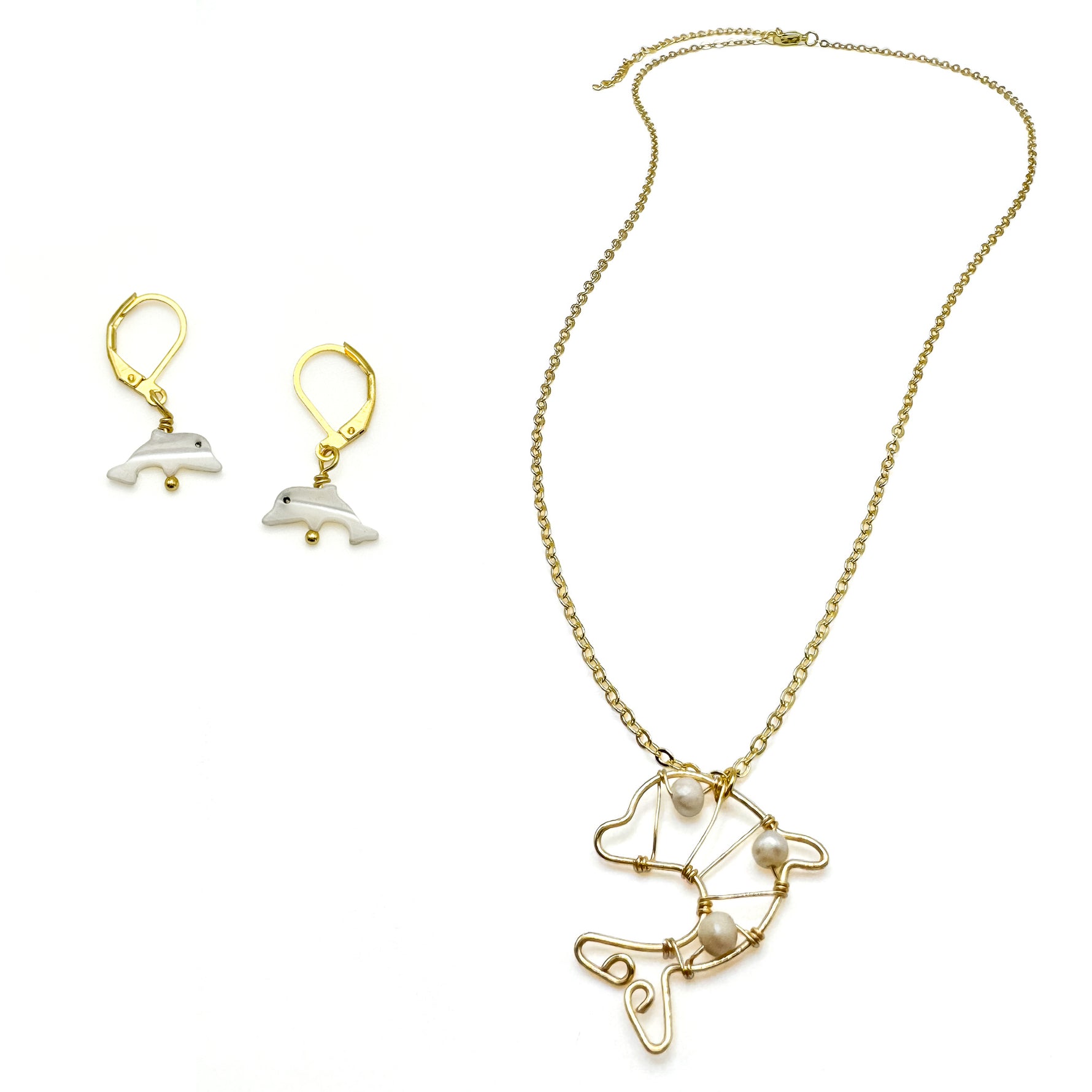 Small mother of pearl dolphin earrings and long gold necklace with wire-wrapped gold and pearl dolphin pendant
