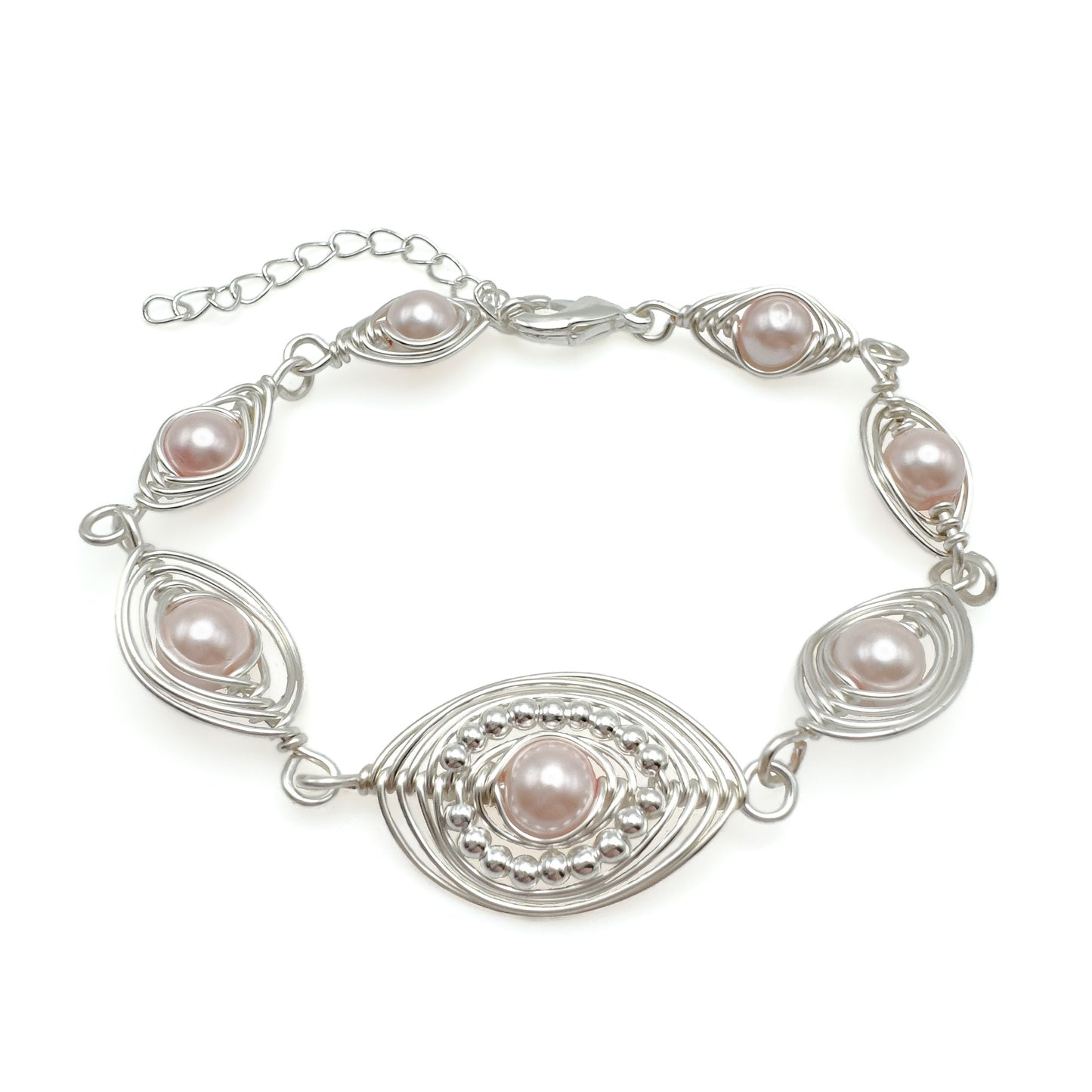 Silver bracelet with pink pearls on a white background