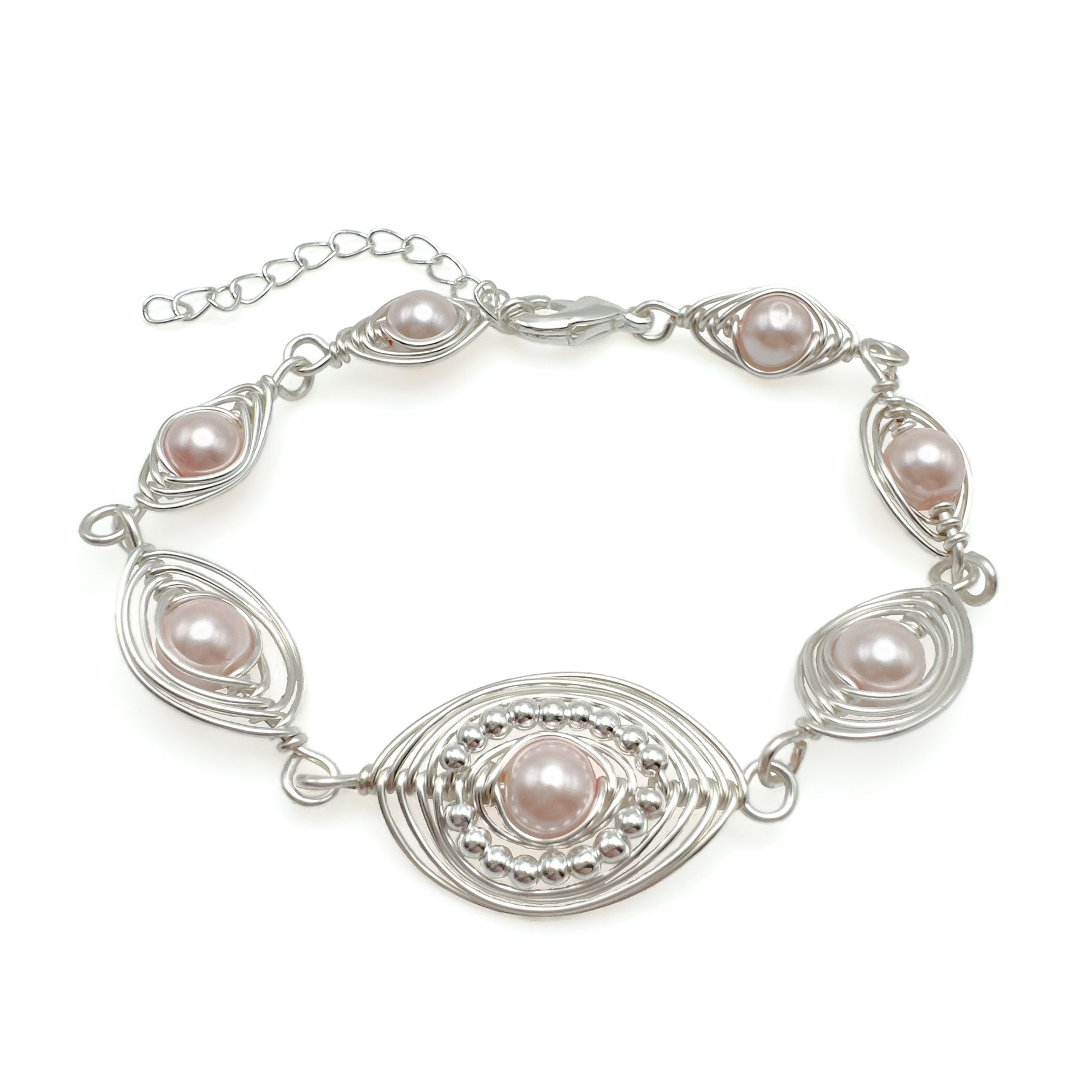 Silver bracelet with pink pearls on a white background