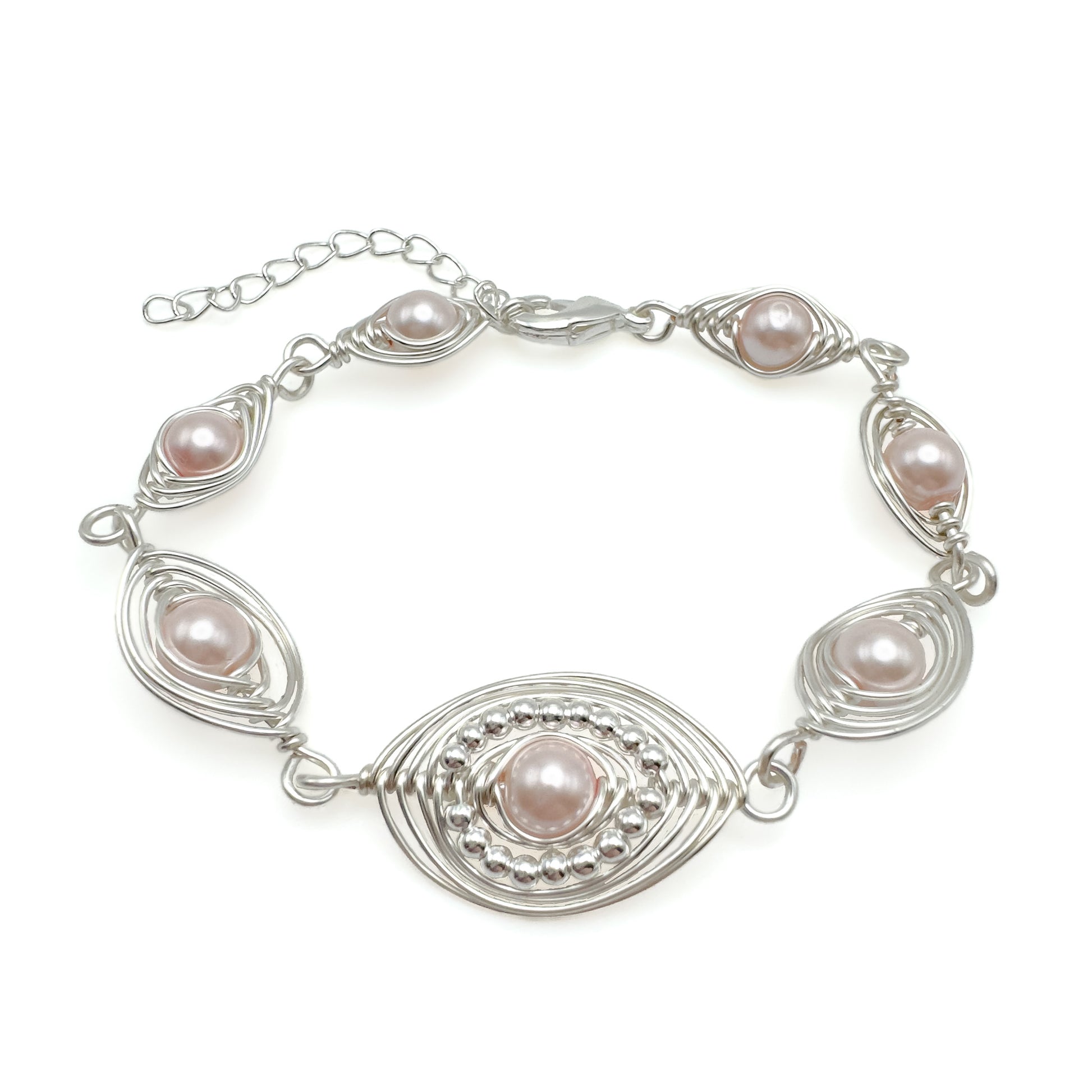 Silver bracelet with pink pearls on a white background