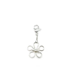 Silver flower-shaped charm on a white background