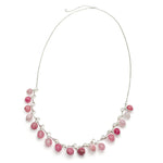 Short silver statement necklace with pink agate beads across front