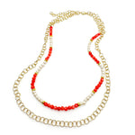 Multistrand gold necklace with beaded strand of coral agate and pearl beads and round gold chain