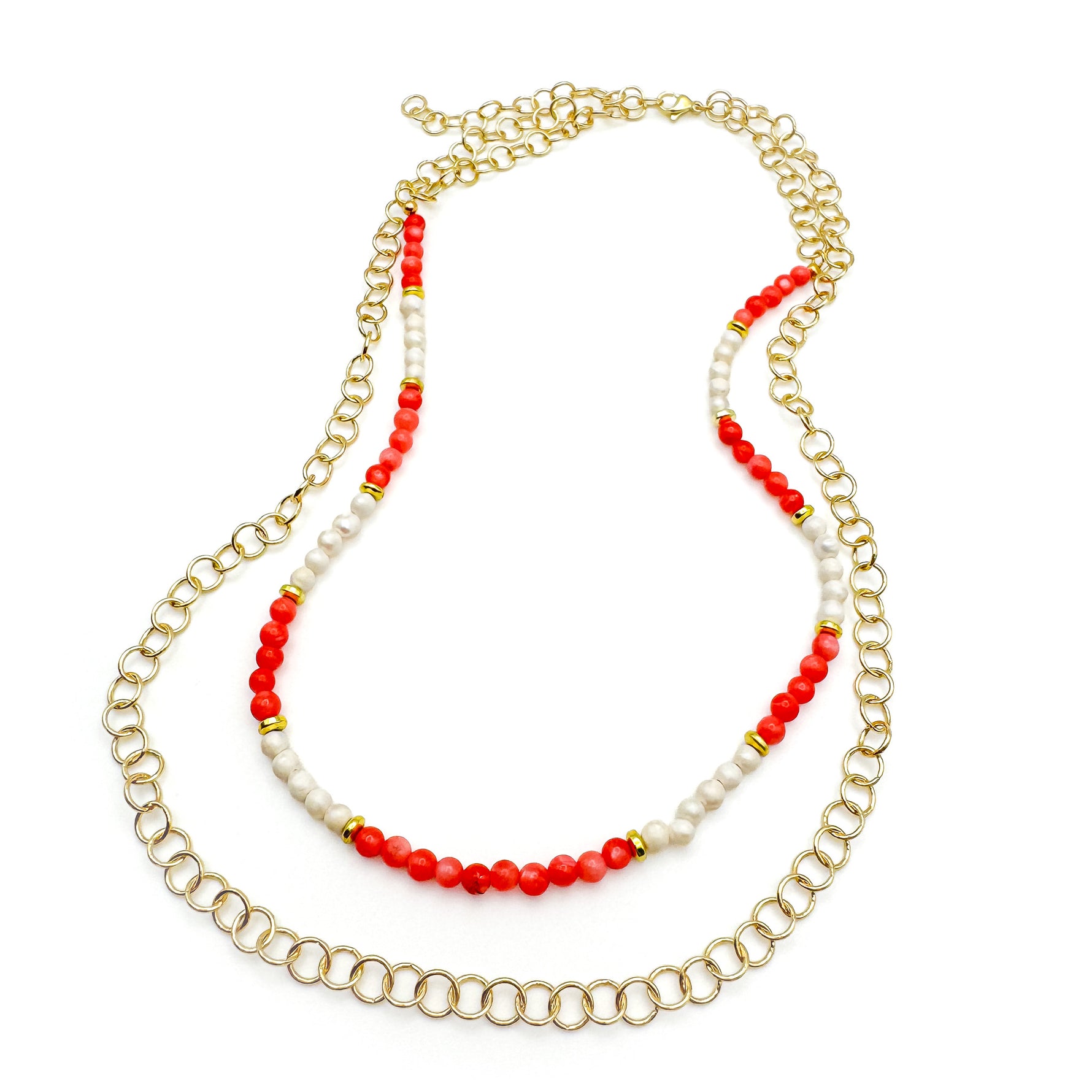 Multistrand gold necklace with beaded strand of coral agate and pearl beads and round gold chain