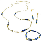 Gold and blue cylindrical agate jewelry set with dangle earrings, beaded stretch bracelet, and long, paperclip chain necklace with agate stations