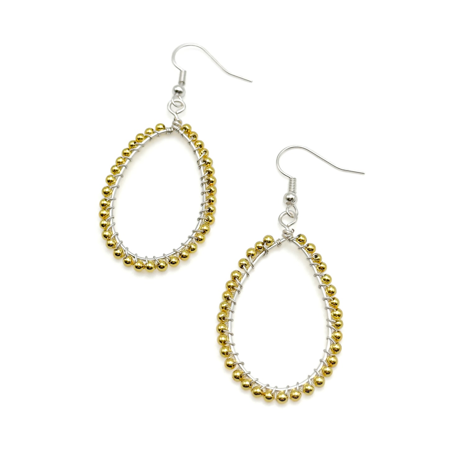 Gold beaded hoop earrings on a white background