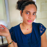 Woman modeling silver chain dangle earrings and choker necklace with pink agate bead and multicolor agate stretch bracelet