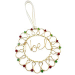 Gold wire-wrapped wreath ornament with red and green crystal adornments and wire-wrapped word Noel in the center