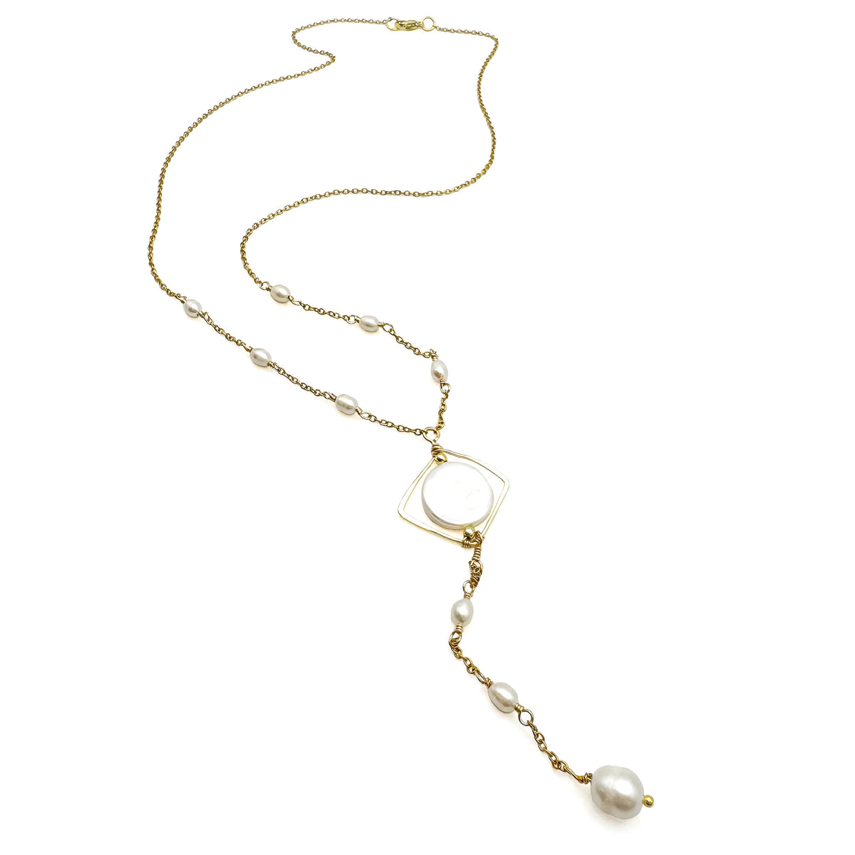 Long, gold y-shaped necklace with pearl stations, isometric mother of pearl pendant, and pearl drops