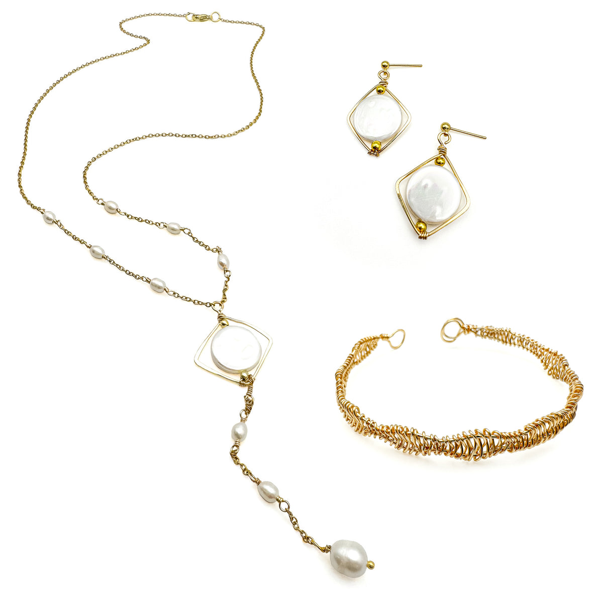 Gold and pearl jewelry set including isometric mother of pearl dangle earrings, intricate wire-wrapped gold cuff bracelet, and Y-shaped necklace with mother of pearl isometric pendant and pearl drop