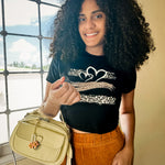 Woman modeling handbag with gold peach blossom flower bag charm