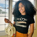 Woman modeling handbag with silver and red flower bouquet bag charm