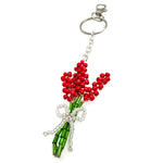 Silver beaded bag charm with red flower bouquet wrapped in clear crystal ribbon