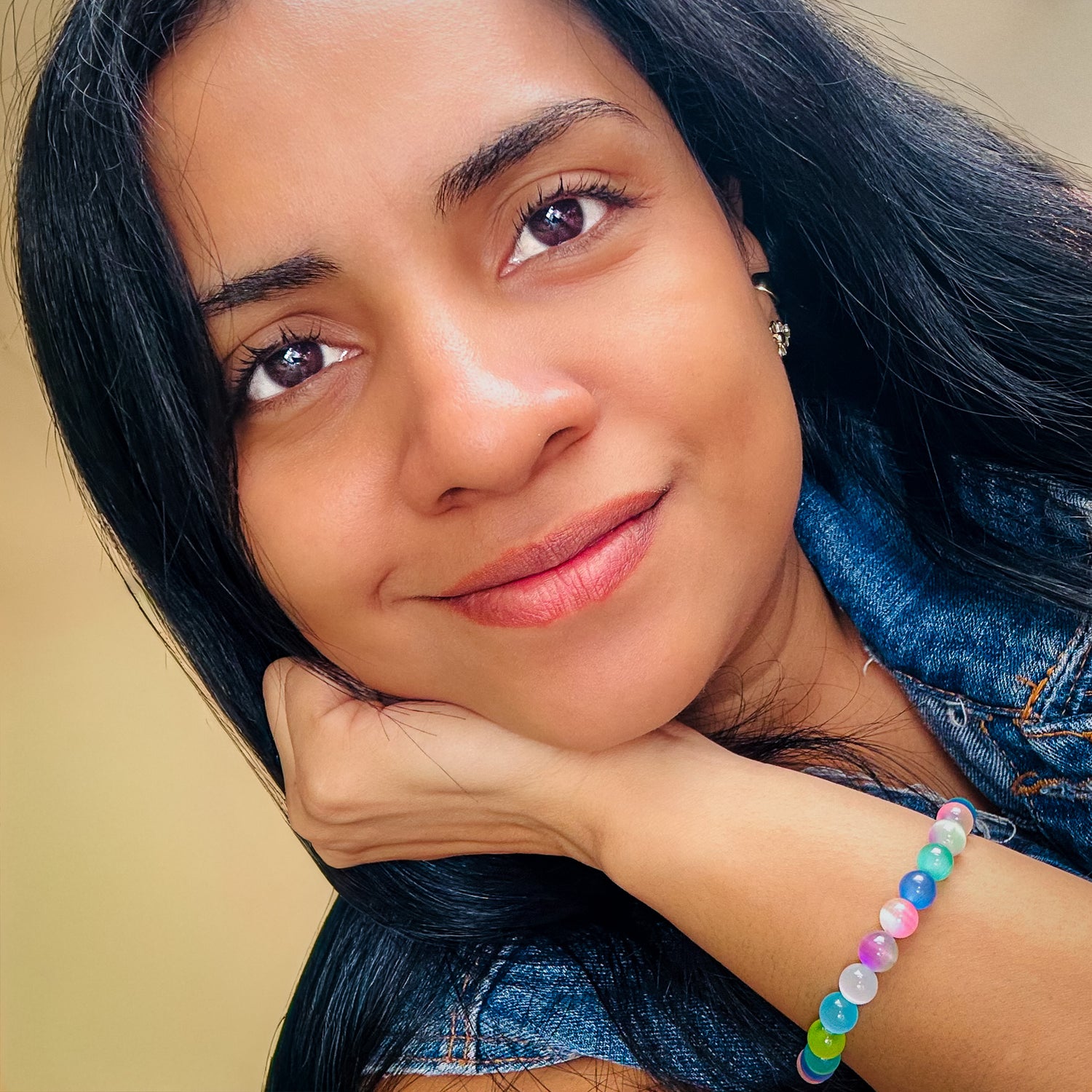 Woman modeling soft rainbow pastel agate stretch bracelet