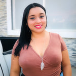 Woman modeling silver long necklace with wire-wrapped leaf pendant
