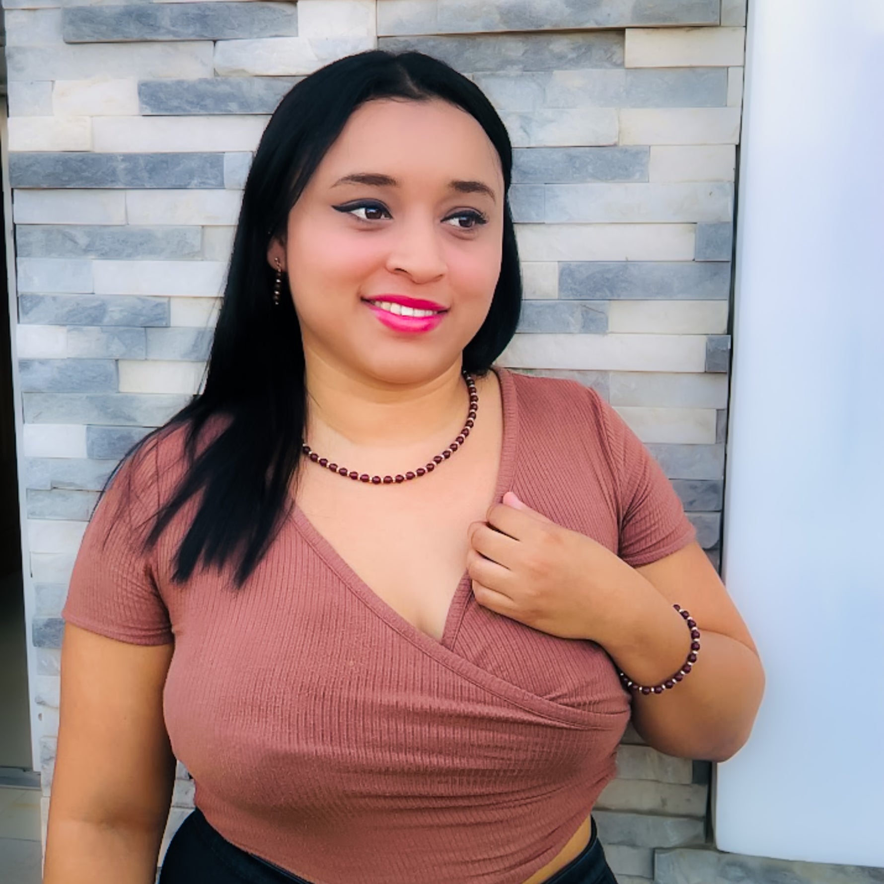 Woman modeling dark brown agate and gold beaded jewelry set with drop earrings, stretch bracelet, and short necklace