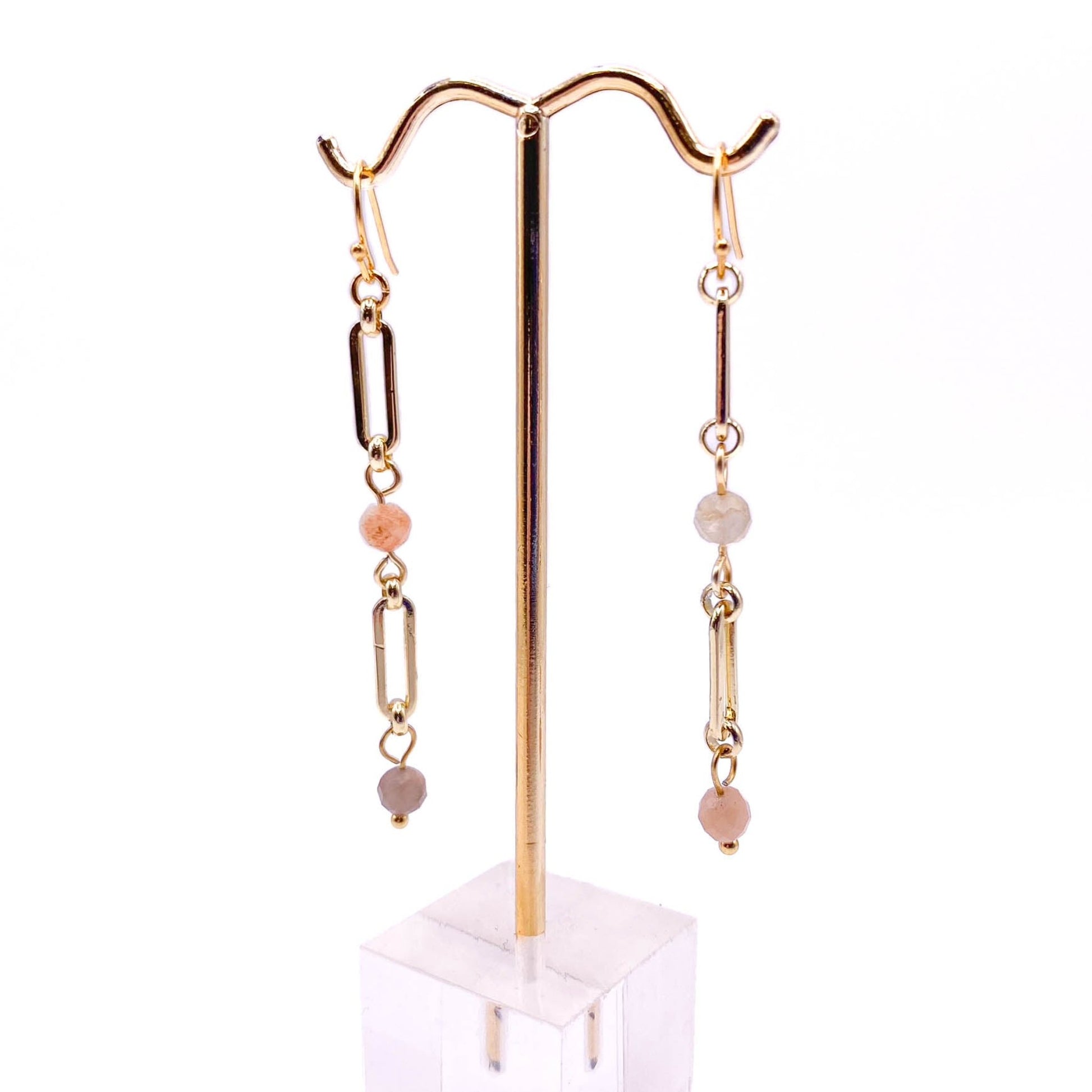 Pink sunstone gold earrings displayed